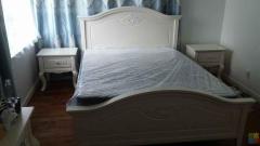 Queen sized wood bed with memory foam mattress and two side cabinets